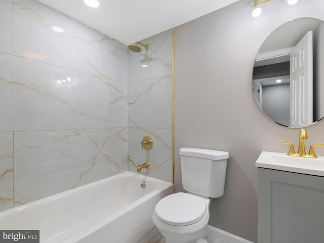 full bathroom with vanity, tiled shower / bath, and toilet