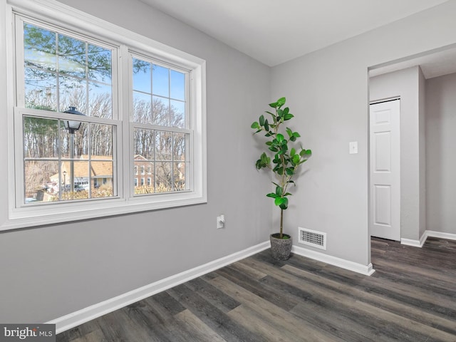 empty room featuring dark hardwood / wood-style flooring