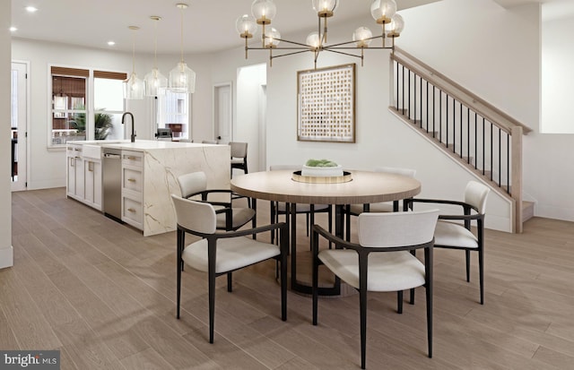 dining area featuring a notable chandelier and light hardwood / wood-style floors