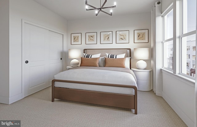 bedroom with a chandelier, light carpet, and a closet