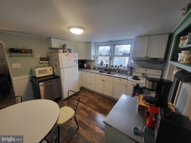 kitchen with white cabinetry, sink, white appliances, and dark hardwood / wood-style flooring