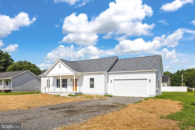 view of front of property featuring a garage and a porch