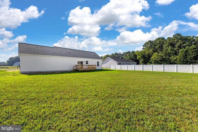 view of yard with a wooden deck and fence