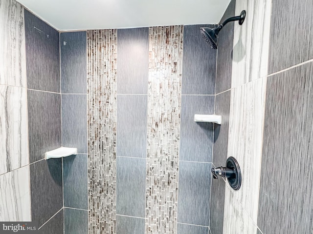 bathroom with a tile shower