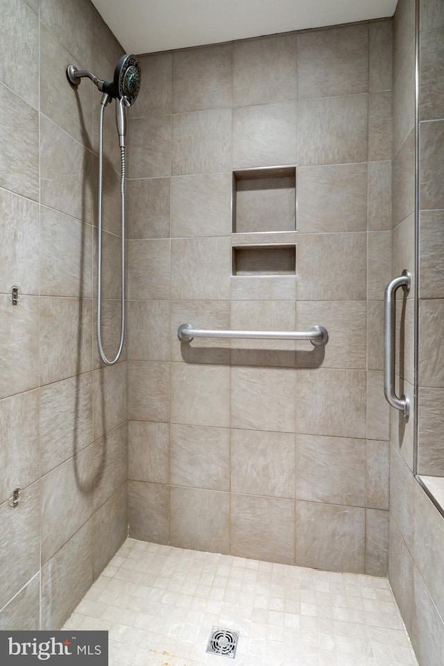 bathroom with tiled shower