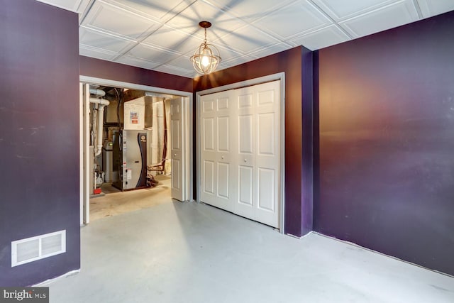 unfurnished bedroom featuring heating unit and concrete floors