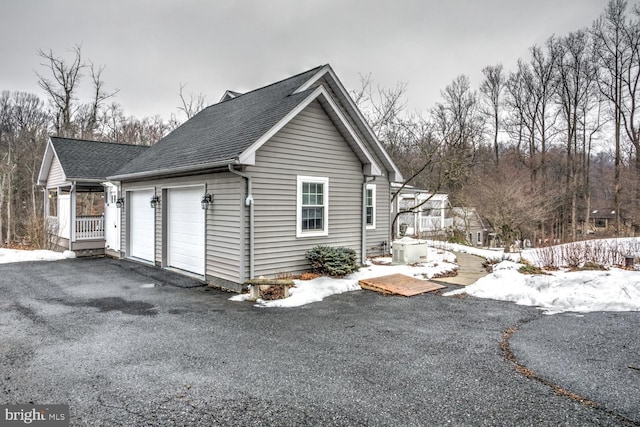 snow covered property featuring a garage