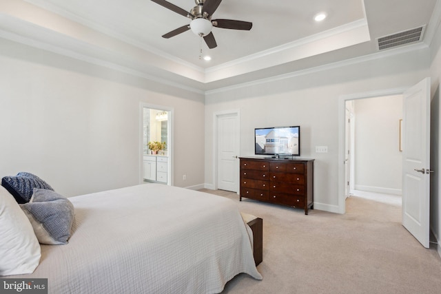 carpeted bedroom with a raised ceiling, crown molding, ceiling fan, and ensuite bath