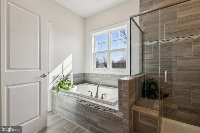 bathroom featuring separate shower and tub