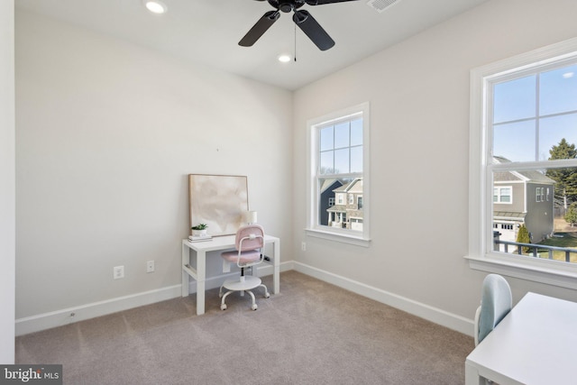 carpeted home office with ceiling fan