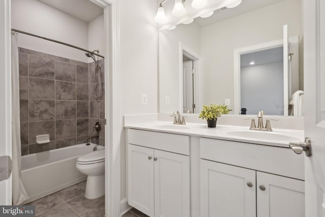 full bathroom featuring vanity, toilet, and tiled shower / bath combo