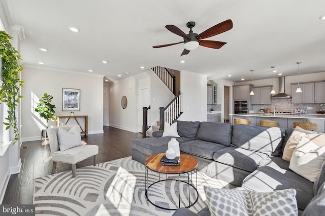 living room with sink, ornamental molding, dark hardwood / wood-style floors, and ceiling fan