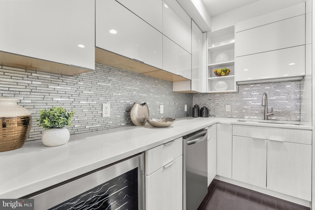 kitchen with sink, stainless steel dishwasher, beverage cooler, decorative backsplash, and white cabinets