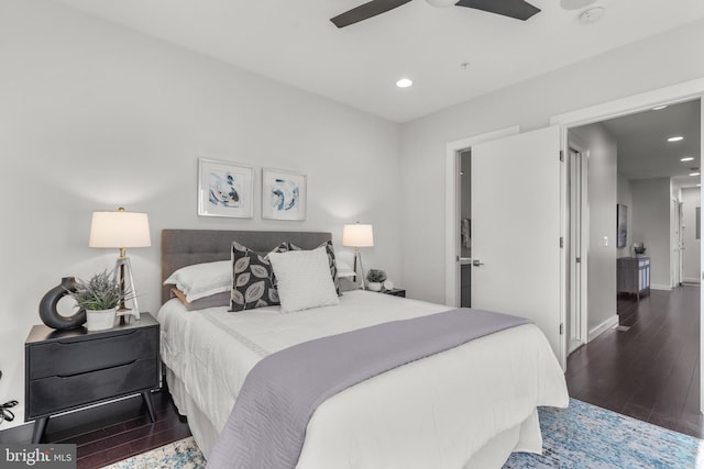 bedroom with dark hardwood / wood-style floors and ceiling fan