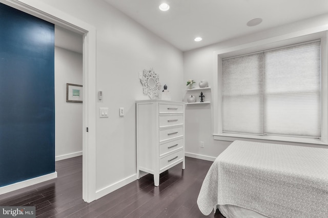 bedroom with dark wood-type flooring