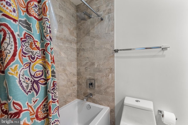 bathroom with shower / bath combo and toilet