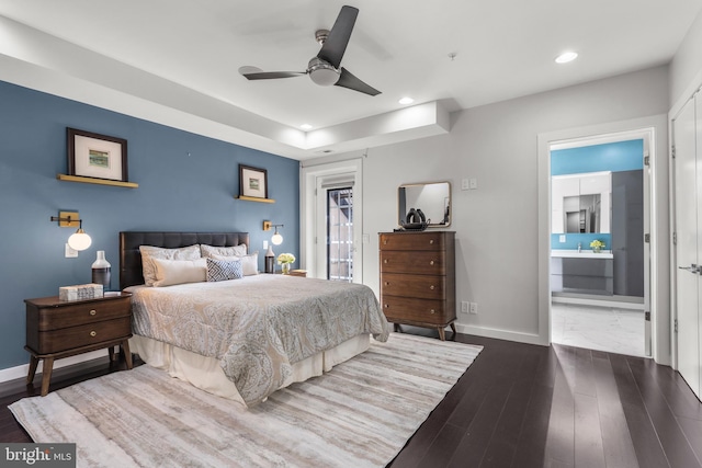 bedroom featuring connected bathroom, access to exterior, dark wood-type flooring, and ceiling fan