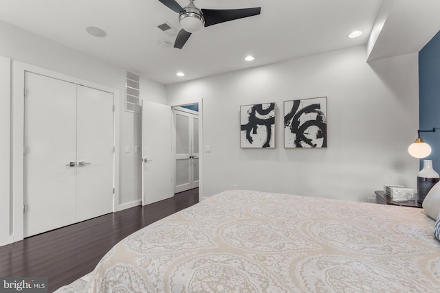 bedroom featuring dark wood-type flooring, a closet, and ceiling fan