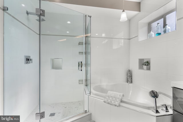 bathroom with shower with separate bathtub