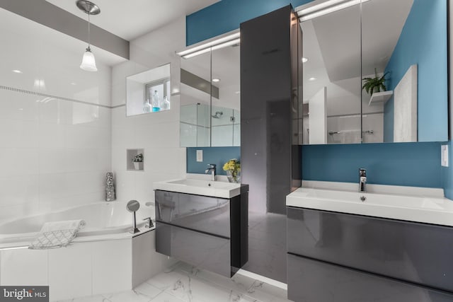 bathroom with tile walls, vanity, and a bathtub