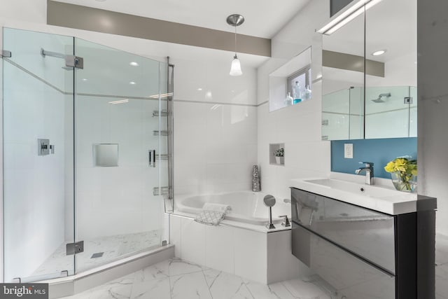 bathroom with vanity and independent shower and bath