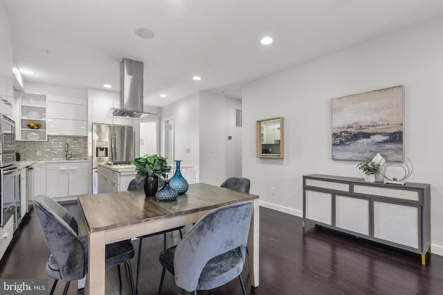 dining room featuring dark hardwood / wood-style floors and sink