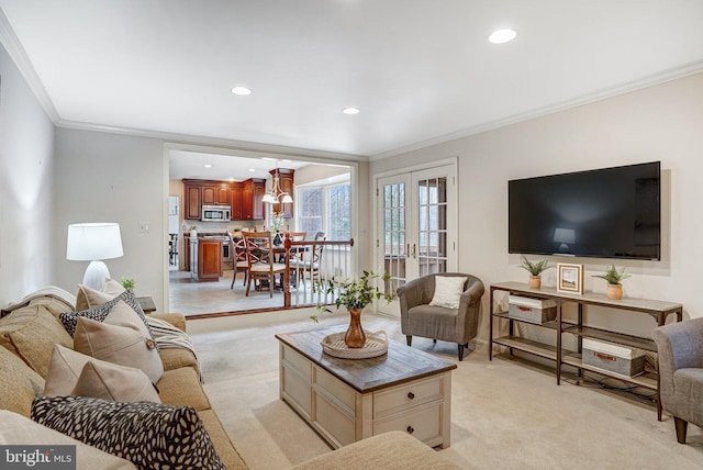 carpeted living room with crown molding and french doors