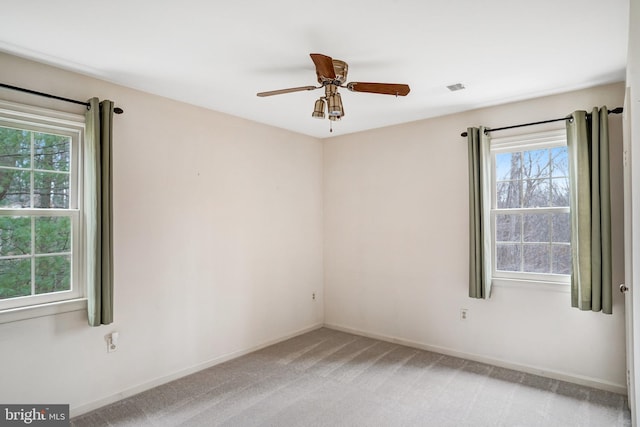 carpeted spare room with ceiling fan