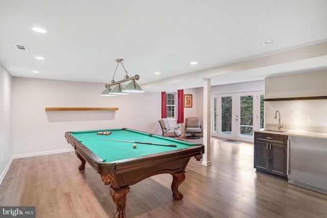 rec room with wet bar, billiards, light hardwood / wood-style flooring, and french doors