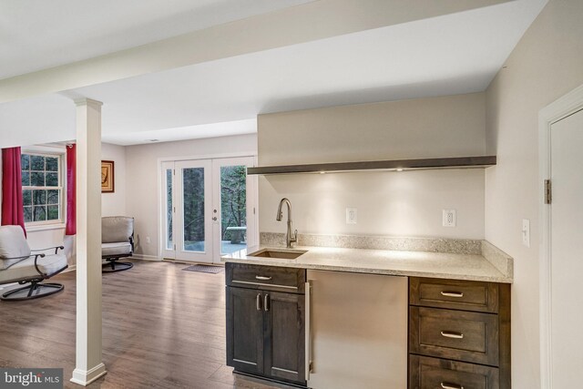 kitchen featuring french doors, dark wood-type flooring, sink, and dark brown cabinets