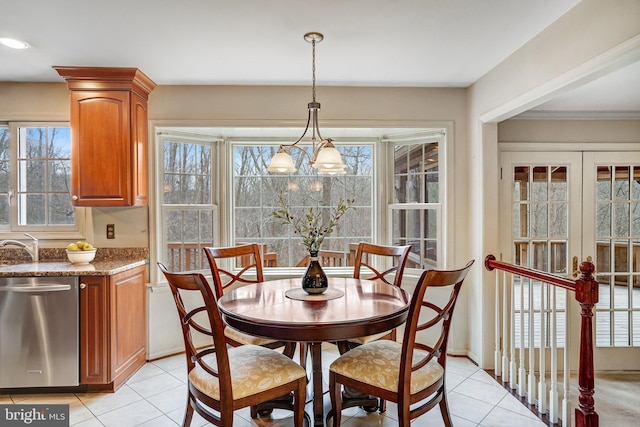 dining space with light tile patterned flooring, plenty of natural light, french doors, and a notable chandelier