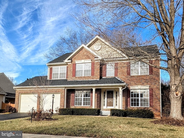 view of front of property featuring a garage and a front yard