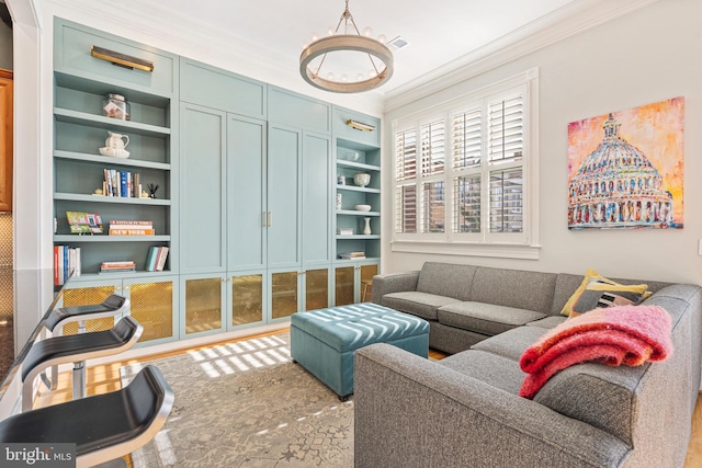 living room with crown molding and built in features