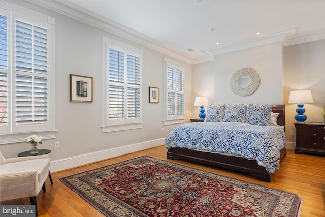 bedroom with crown molding and hardwood / wood-style floors