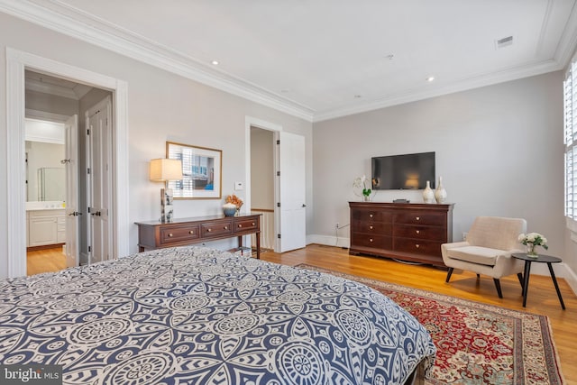 bedroom with ornamental molding and light hardwood / wood-style floors