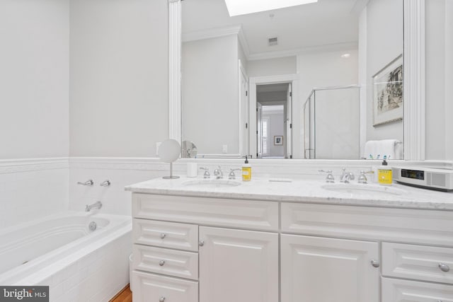 bathroom featuring vanity, separate shower and tub, ornamental molding, and a skylight