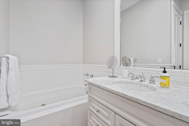 bathroom featuring vanity and a relaxing tiled tub