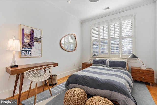 bedroom featuring wood-type flooring and crown molding