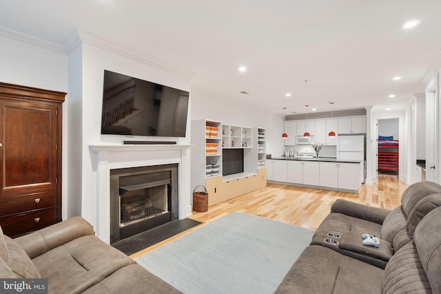 living room featuring crown molding and light wood-type flooring