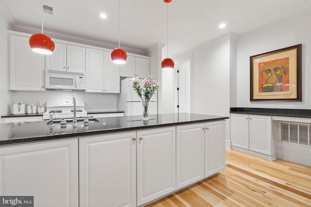 kitchen with white cabinetry, sink, white appliances, and decorative light fixtures