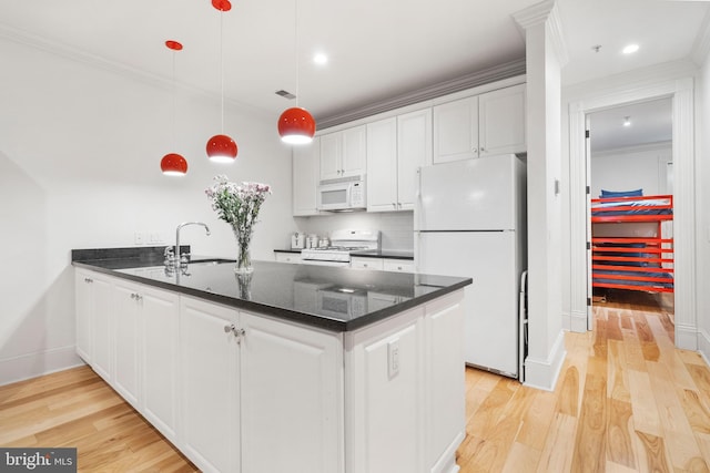 kitchen featuring decorative light fixtures, sink, white cabinets, light hardwood / wood-style floors, and white appliances