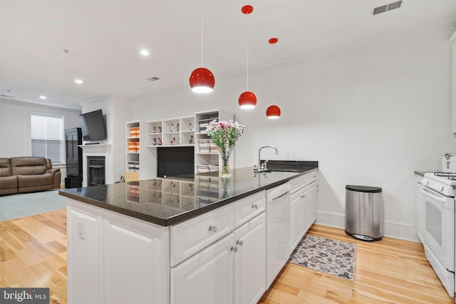 kitchen with pendant lighting, sink, white cabinets, ornamental molding, and white appliances