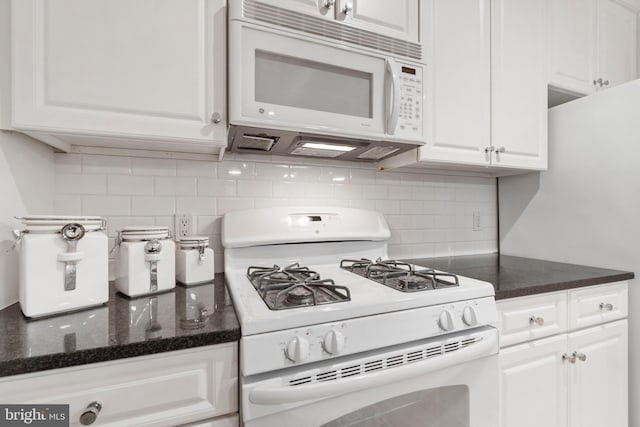 kitchen featuring backsplash, white cabinets, and white appliances