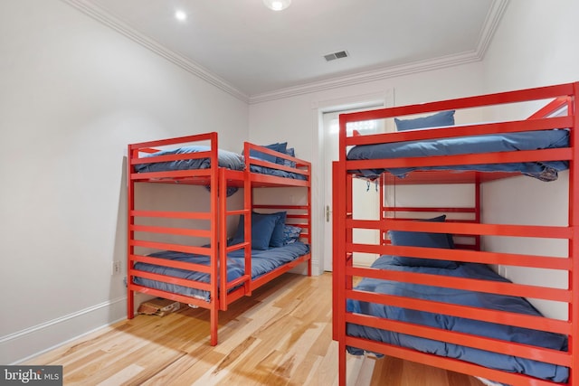 bedroom featuring hardwood / wood-style flooring and ornamental molding