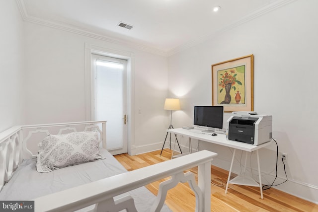 bedroom with hardwood / wood-style floors and ornamental molding