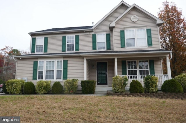 view of front property with a porch and a front lawn