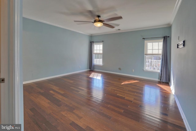 empty room with a healthy amount of sunlight, ornamental molding, and dark hardwood / wood-style floors