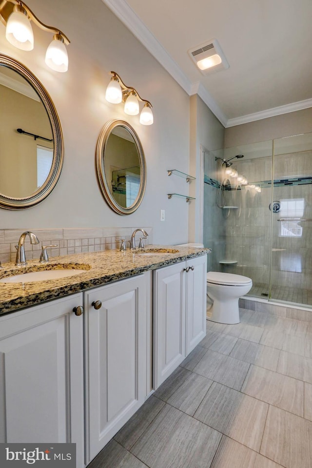 bathroom featuring vanity, a shower with shower door, ornamental molding, and toilet