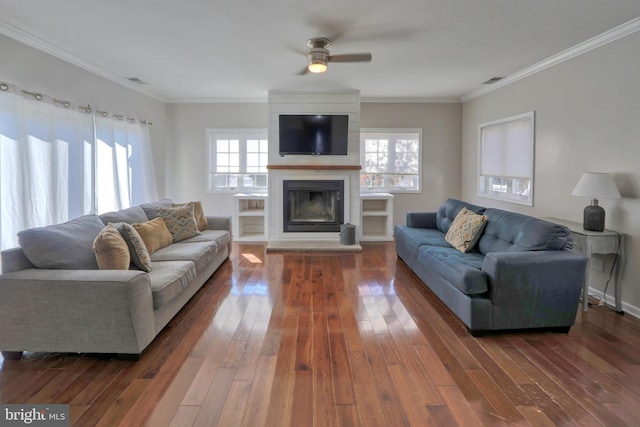 living room with crown molding, dark hardwood / wood-style floors, and a fireplace