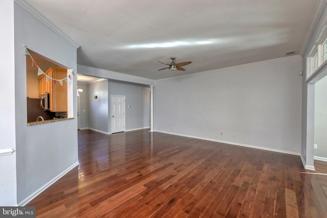 interior space featuring dark wood-type flooring, ornamental molding, and ceiling fan